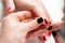 Manicure. Master applies varnish drawing on nails gel in spa . Closeup finger nail care by specialist in beauty salon.