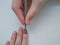 The manicure master processes the cuticle to the client. Tool for nails.