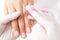 Manicure master removes dust from nails