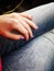 Manicure with purple varnish on the hand of a white young girl