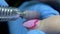 The manicure removes red nail polish with its electric file