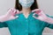 Manicure tools in hands of female manicurist wearing mask and gloves