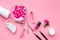 Manicure tools set for nail care on rose background top view