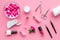 Manicure tools set for nail care on rose background top view