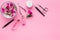 Manicure tools set for nail care on rose background top view mock up