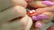 Manicure - Volume floristry on nails. manicurist working closeup.