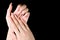 Manicured girl hands on a black background. Pink coral nails