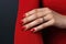 Manicured hand with red nail polish