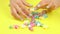 Manicured hands and colored candies.