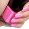 Manicured nails with bright nail polish. Manicure with pink nailpolish. Fashion manicure. Shiny gel lacquer in bottle