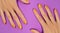 Manicured womans with trendy nail design on purple background