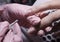 The manicurist applies a layer of gel Polish to the client`s nail.