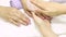 The manicurist applies a moisturizer to the client`s hand. SPA manicure, procedure, moisturizing. Hand lotion, cream. Skin care. B