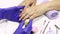 The manicurist applies a moisturizing oil to the cuticle. SPA manicure, procedure, moisturizing. Skin care. Beauty salon. Manicure