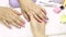 The manicurist applies a moisturizing oil to the cuticle. SPA manicure, procedure, moisturizing. Skin care. Beauty salon. Manicure