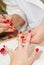 Manicurist applying red nail