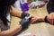 Manicurist with black protective mask work on a woman client hands, Professional works in gloves for sterility