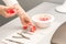 Manicurist decorates table with petals