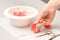 Manicurist decorates table with petals