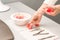 Manicurist decorates table with petals