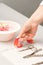 Manicurist decorates table with petals