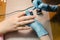 Manicurist makes hardware manicure close-up. Treatment of nails with the help of hardware manicure