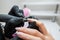 A manicurist makes a hardware manicure to a client of a beauty salon. The process of removing the cuticle cutter close-up