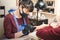 Manicurist makes a manicure to the client, using a manual electric milling machine in the beauty salon