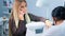 Manicurist makes manicure for a woman in a beauty salon. A blonde woman is talking on the phone during a manicure.