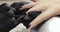 Manicurist master covering painting client\'s nails black shellac, hands closeup.