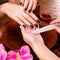 Manicurist master makes manicure on woman\'s hands