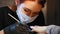 Manicurist in medical mask doing professional manicure in beauty shop