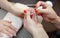 The manicurist paints nails with nail polish during the procedure of nail extensions with gel in the beauty salon.