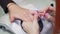 Manicurist paints nails with a very thin brush