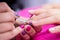 Manicurist polish nails on women`s hand in nail salon