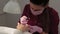 Manicurist polishes nails with a client in a beauty salon.