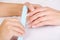 Manicurist polishing female fingernails