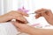 Manicurist preparing client`s fingernail cuticles in salon