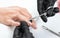 A manicurist removes cuticles during a nail extension procedure in a beauty salon. Professional hand care