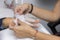 Manicurist removes paraffin wax of female hand
