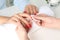 Manicurist removing polish from client`s nails in salon