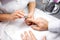 Manicurist rounding the edges using nail file