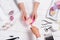 manicurist showing samples of nail varnishes to woman