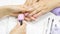 The manicurist shows the client the color of nail Polish. The woman chooses the color of the gel Polish. Pink manicure, Nude,