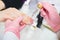 A manicurist takes care of the client`s hands. Closeup photo in beauty salon