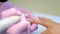 Manicurist woman removes shellac gel using manicure machine, hands closeup.