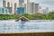 Manila, Philippines - Feb 02, 2020. A man swims a front crawl in a pool on the roof of a luxury hotel. View of the city of Manila