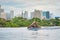 Manila, Philippines - Feb 02, 2020. A man swims a front crawl in a pool on the roof of a luxury hotel. View of the city of Manila