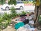 Manila, Philippines - A homeless man with his child sleeps on a makeshift bed made of cardboard near a tree along an