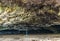 Maniniholo Dry Cave on Kauai Island, Hawaii. People exploring the cave.